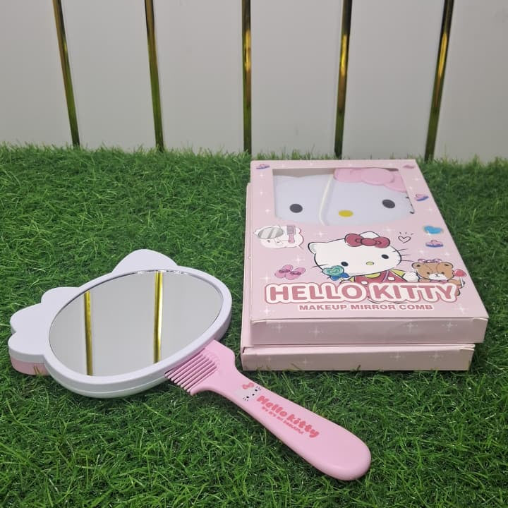 Hello Kitty brush and mirror set on grass with a white background