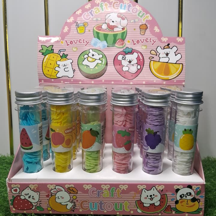 Display of colorful hair ties in a cartoon-themed holder on a grassy background