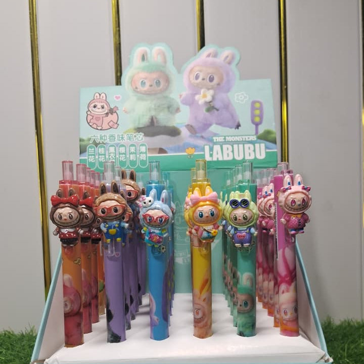 Display of colorful Labubu toys in a box on grass with a white background