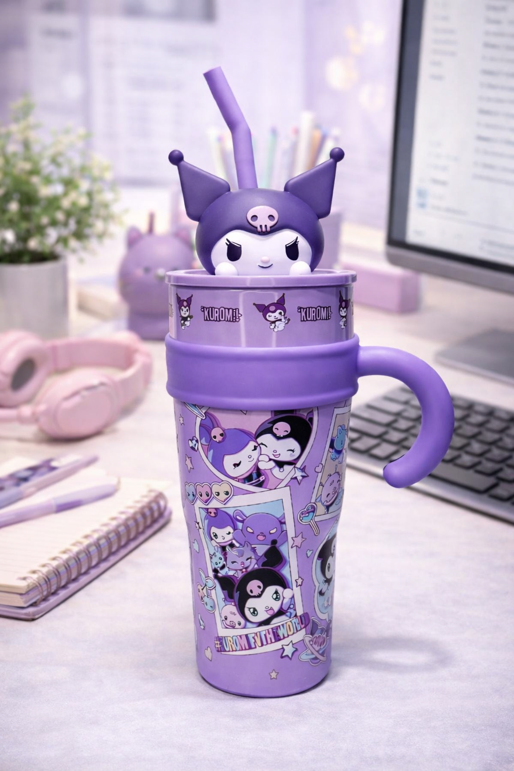Purple character-themed tumbler with a straw on a desk.