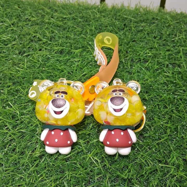 Two cartoon character figurines with red hats on a grassy surface