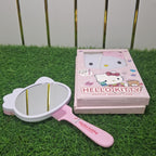 Hello Kitty brush and mirror set on grass with a white background